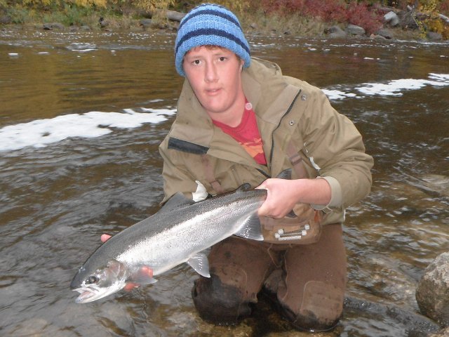 Austin with a Fall steelhead from the Beaver River.JPG - Austin with a Fall steelhead from the Beaver River